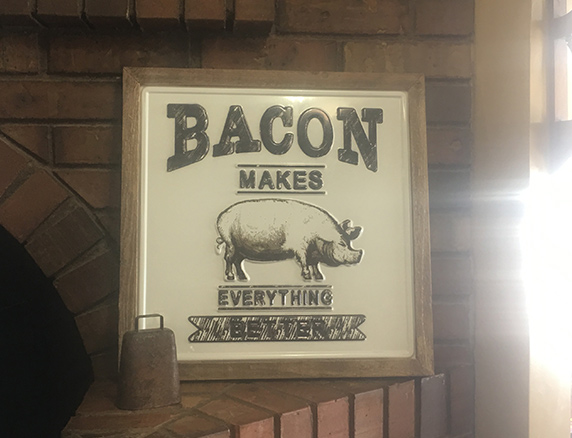 Bacon Makes Everything Better sign by the fireplace