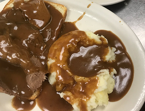 Open-faced beef with gravy and mashed potatoes