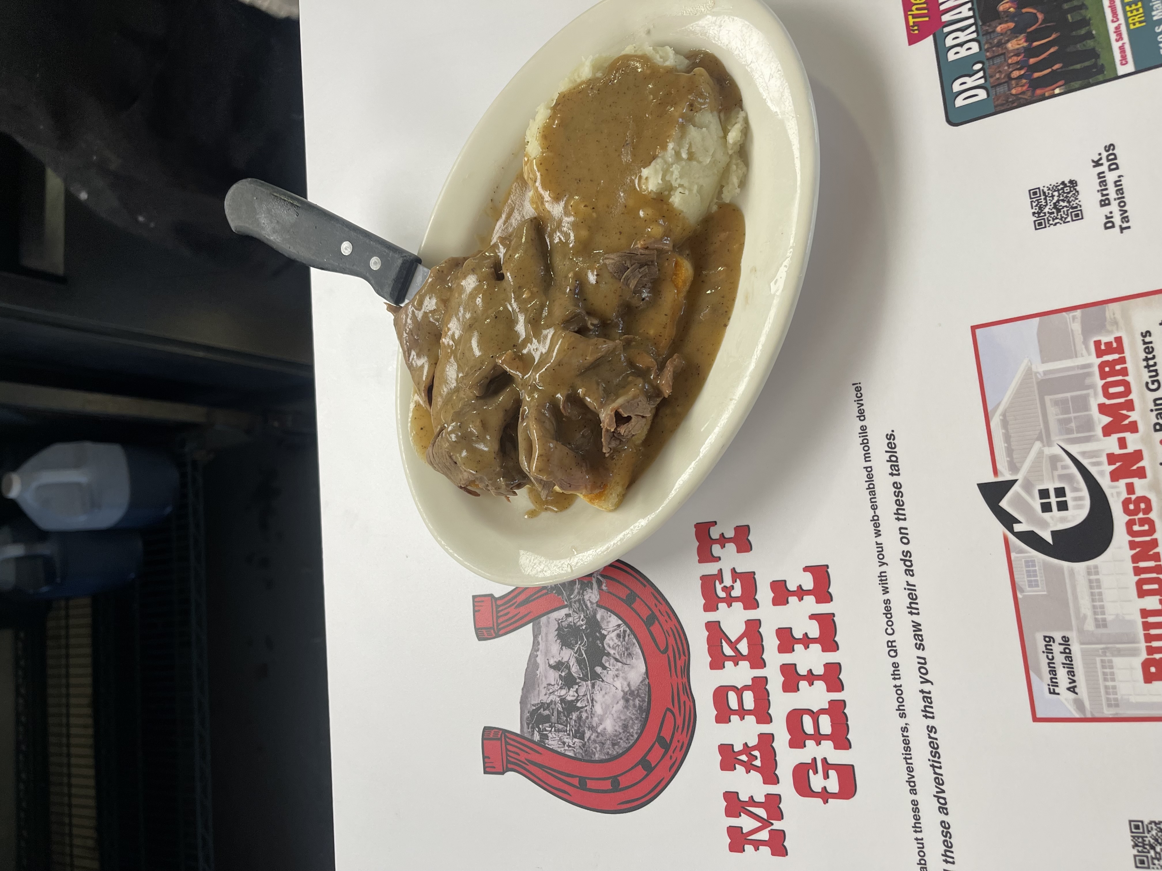 Roast beef dinner with gravy and mashed potatoes
